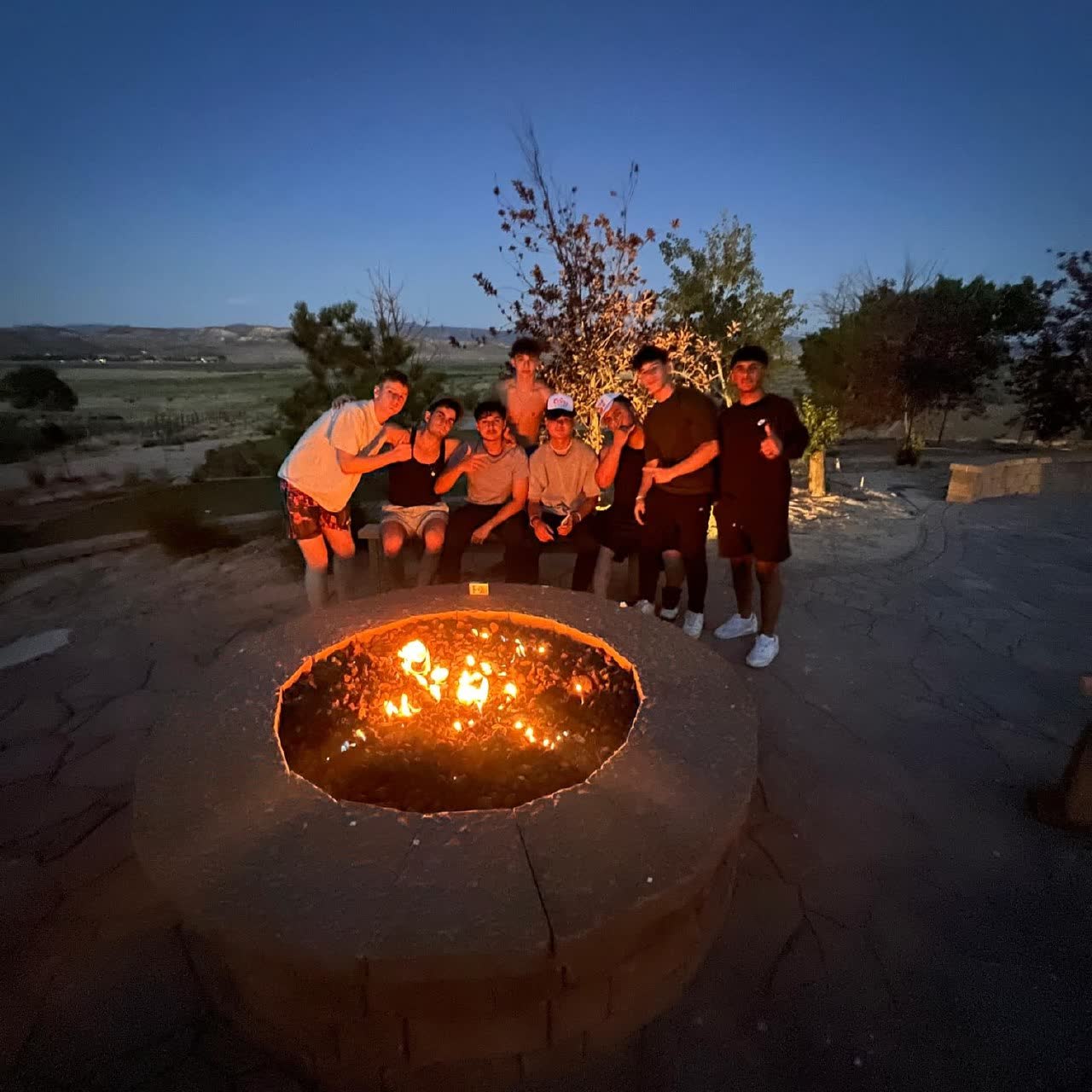 Group by a campfire at dusk